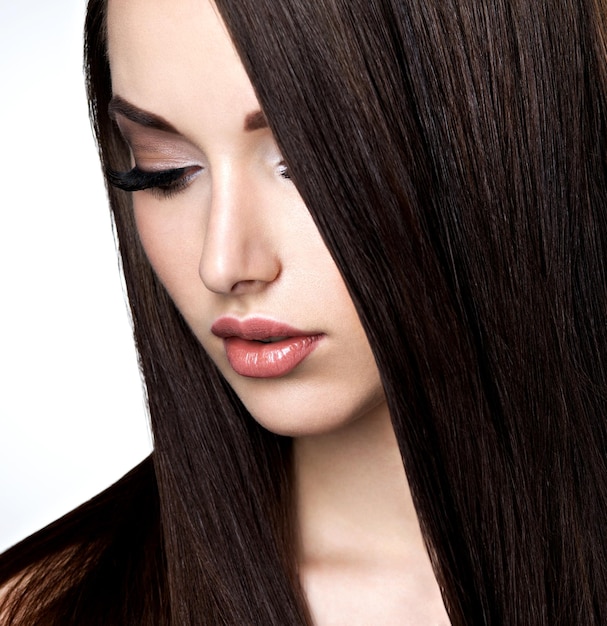 Face of beautiful young woman with brown make-up and  straight  hair