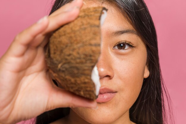 Face being covered by half of coconut