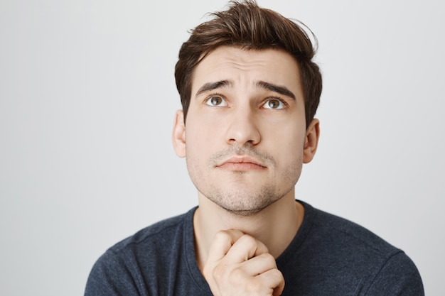 Free photo face of hopeful gloomy man praying and looking up