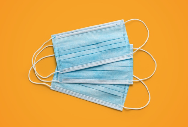 Free photo face masks on a yellow background