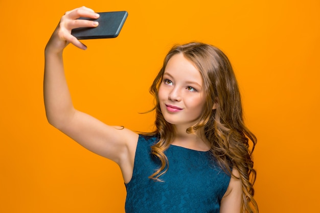 Face of playful happy teen girl with phone