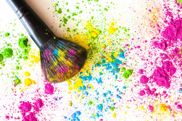 Face powder with makeup brush on white backdrop