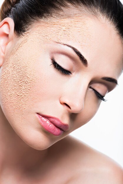 Face of a woman with cosmetic powder on skin