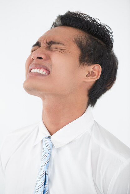 Face of young Asian businessman in despair