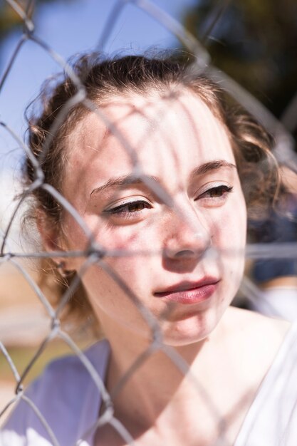 Face of young girl at grid