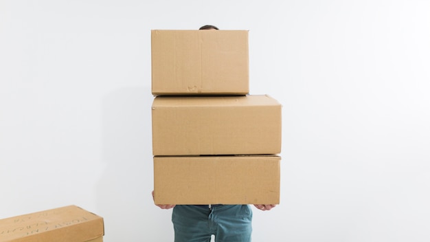 Free photo faceless man carrying boxes