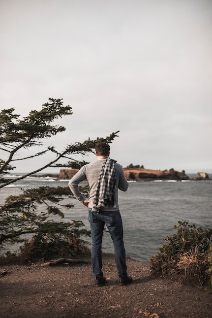 Free photo faceless man looking at river