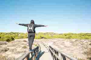 Free photo faceless man walking on railings