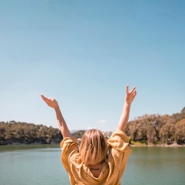 Free photo faceless woman gesturing peace