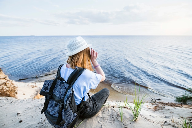 Faceless woman looking at sea