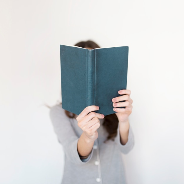 Faceless woman with book