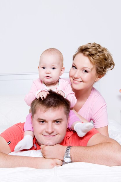 Faces of the happy young and joyful family people at home