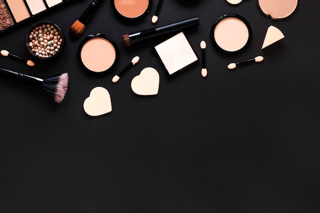 Free photo facial powders with powder brushes on table