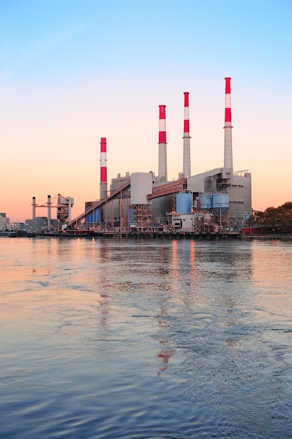 Factory over river at dusk