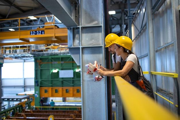 Factory workers talking in production hall