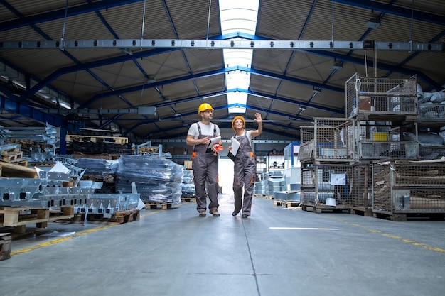 Factory workers walking through large production hall