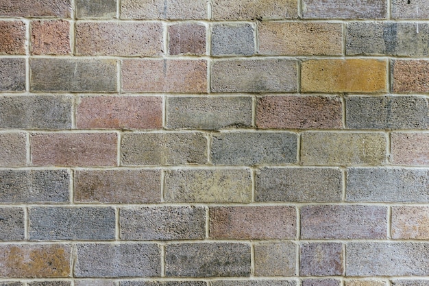 Faded colored brick wall textured wallpaper