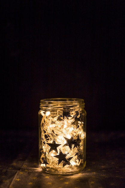 Free photo fairy lights and ornament stars in tin