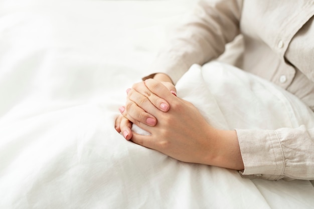 Free photo faithful woman praying in bed