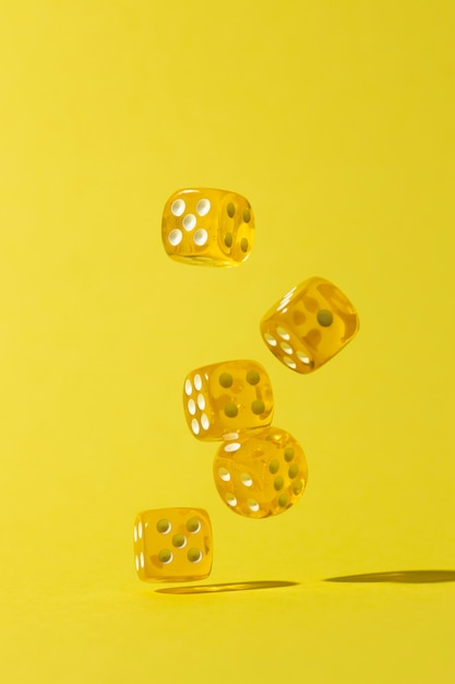 Falling yellow dices on yellow background