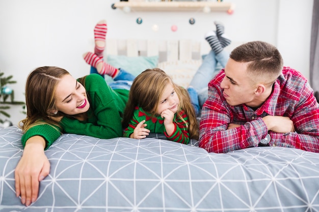 Family on bed at christmas