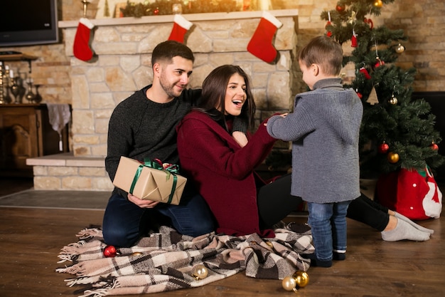 Family by the chimney on Christmas