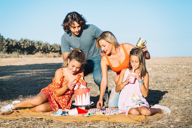 Family celebrating birthday on picnic