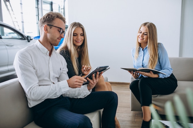 Family choosing a car in a car showroom