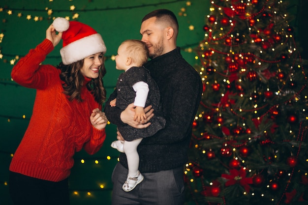 Free photo family on christmas by the christmas tree