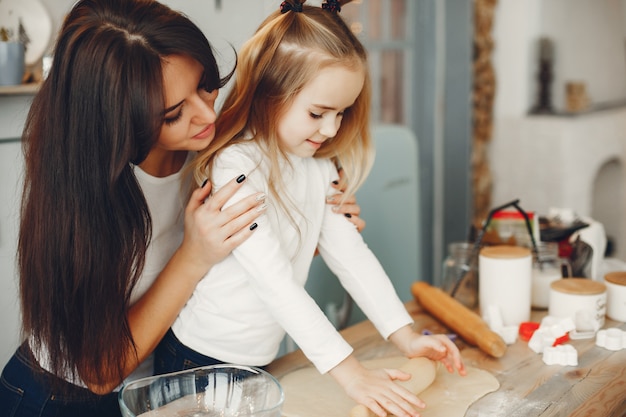 Family cook the dough for cookies