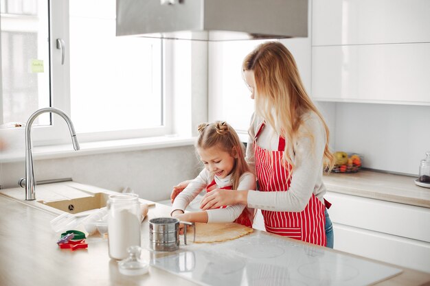 Family cook the dough for cookies