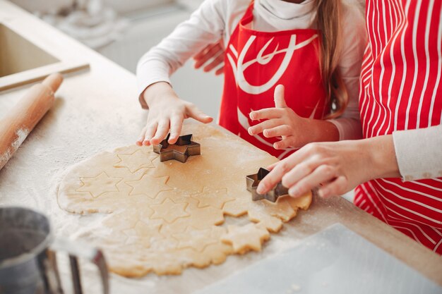 Family cook the dough for cookies