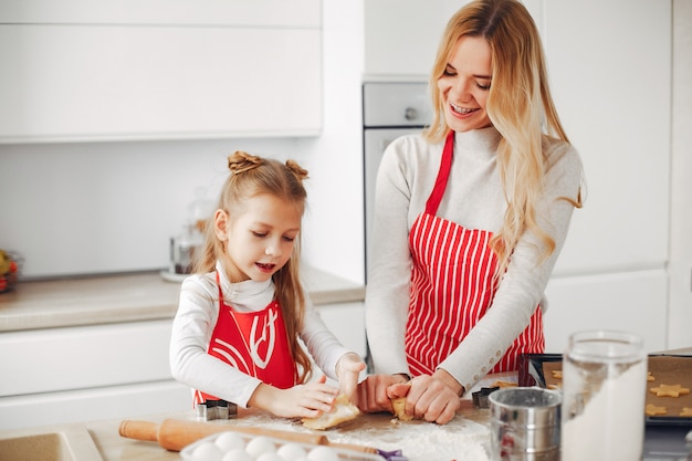 Family cook the dough for cookies