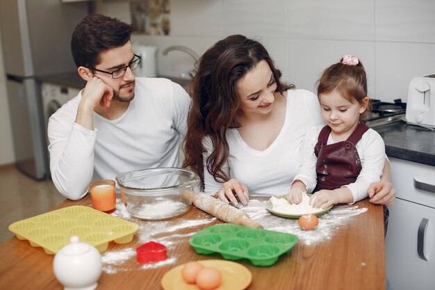 Family cook the dough for cookies