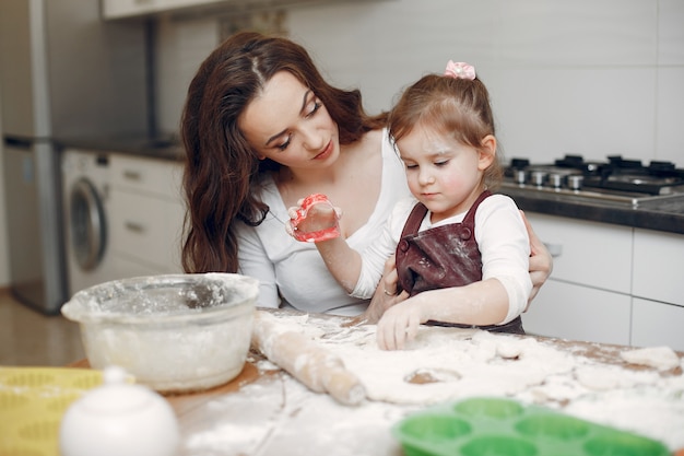 Family cook the dough for cookies