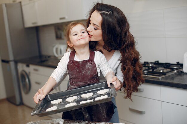 Family cook the dough for cookies