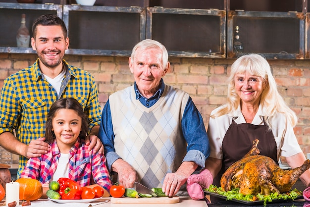 Family cooking turkey with vegetables 