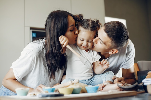 Family cooks the dough for cookies at the kitchen