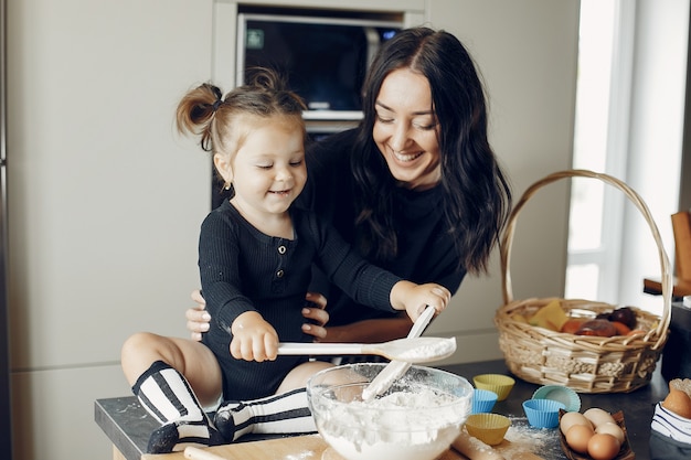 Family cooks the dough for cookies