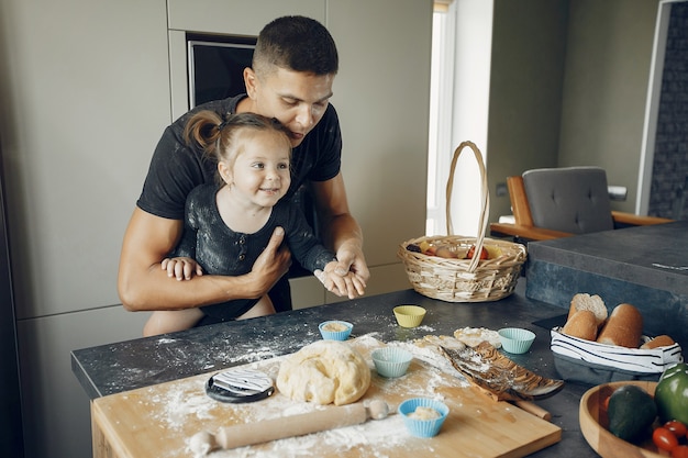 Family cooks the dough for cookies