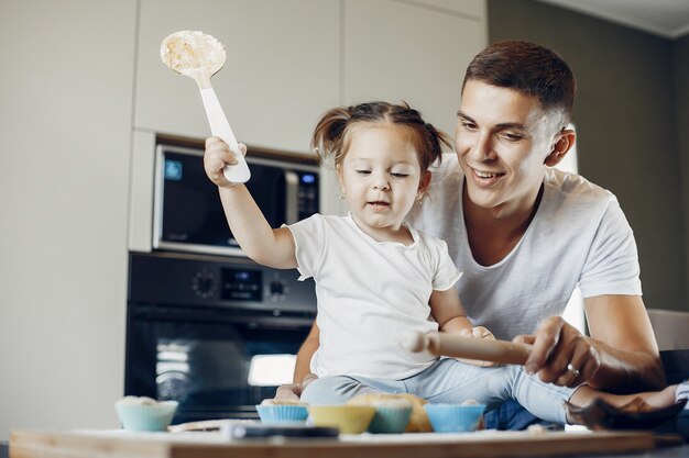 Family cooks the dough for cookies