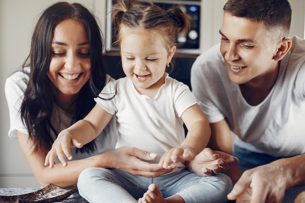 Family cooks together in the kitchen 