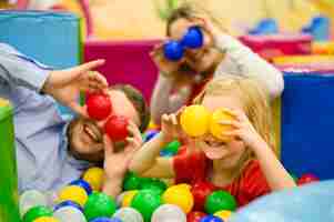 Free photo family covering eyes with balls