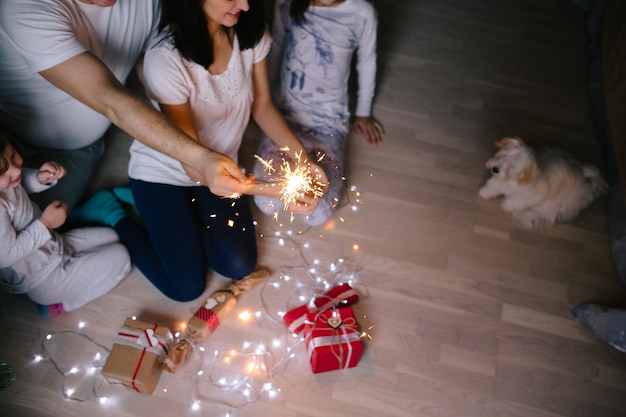 Family and dog with sparkling lights