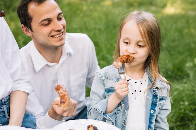 Free photo family doing a barbecue in nature