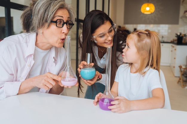 Family doing chemical experiment mixing flasks indoors