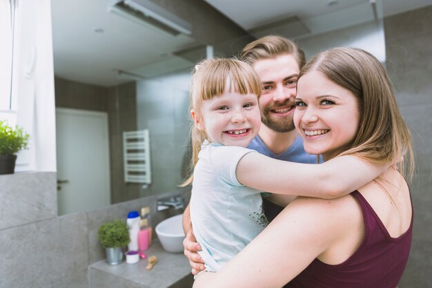 Family embracing in bathroom