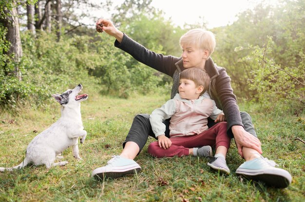 Family enjoying nature with pet