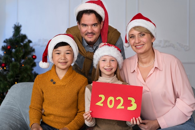 Family of four celebrating new years eve at home together