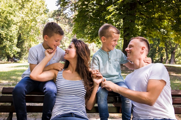 Family of four resting on a bench